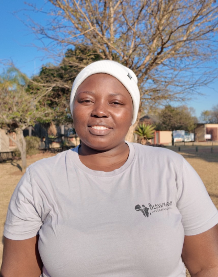 Rebecca Kwakwa of Blessman International standing on the Blessman International campus.